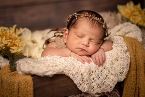 newborn session sleeping baby head on hands