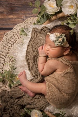 newborn session sleeping baby greenery and flowers