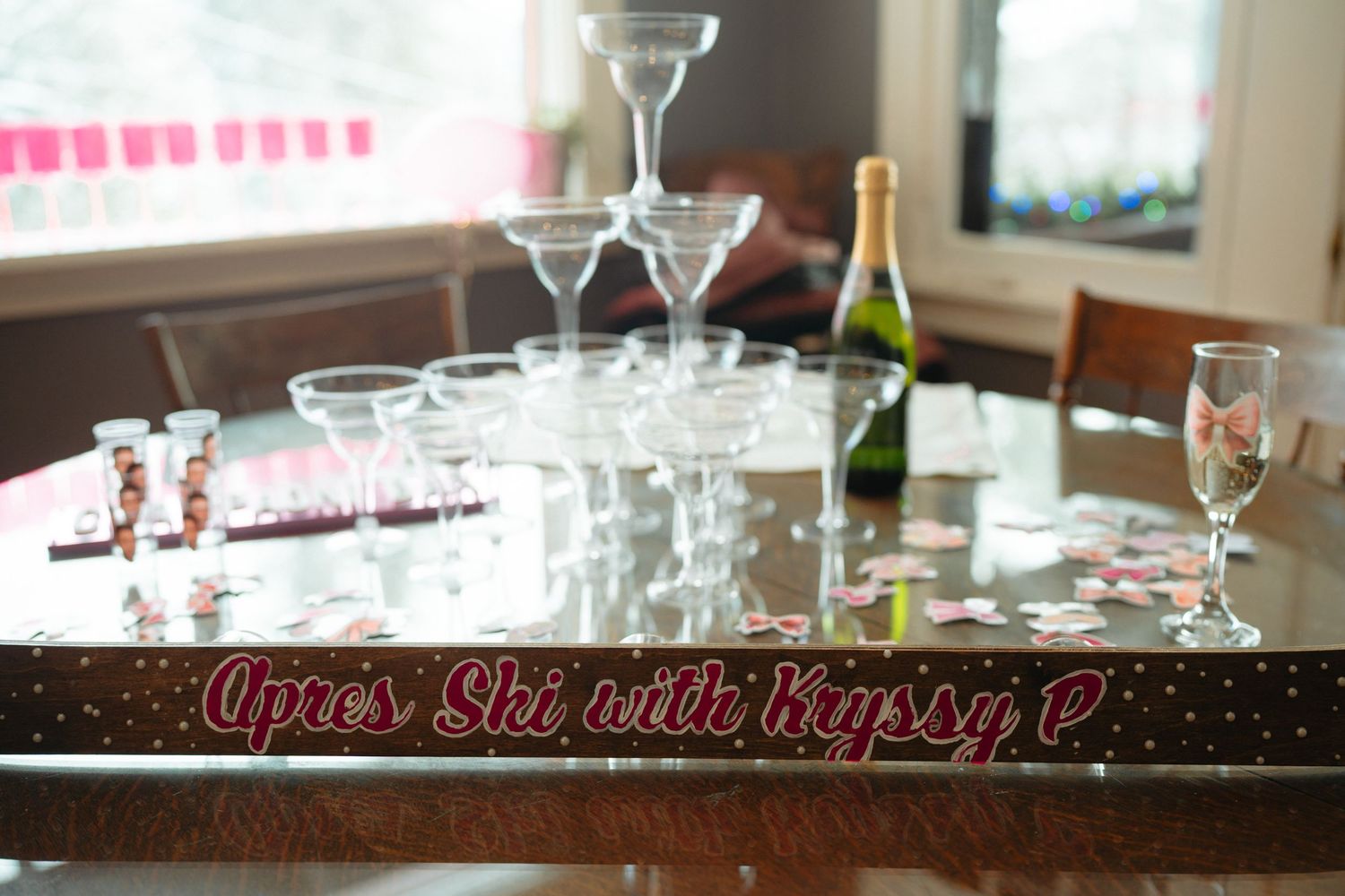 Elegant wine glasses and table settings arranged in a row at an upscale restaurant or event venue.