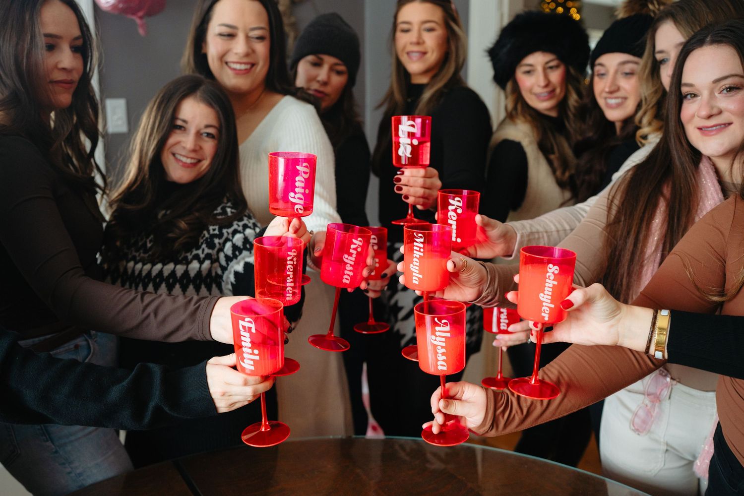 Friends holding red cups while socializing and having fun at a holiday gathering.