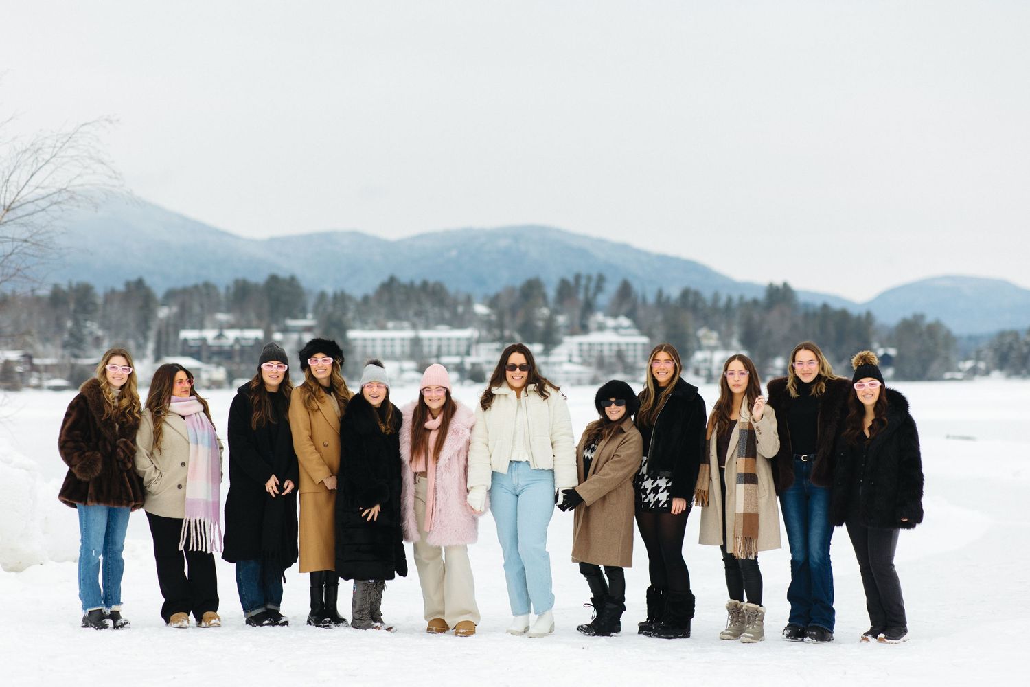 A panoramic series of winter group photos showing people lined up in the snow wearing coats in neutral colors.