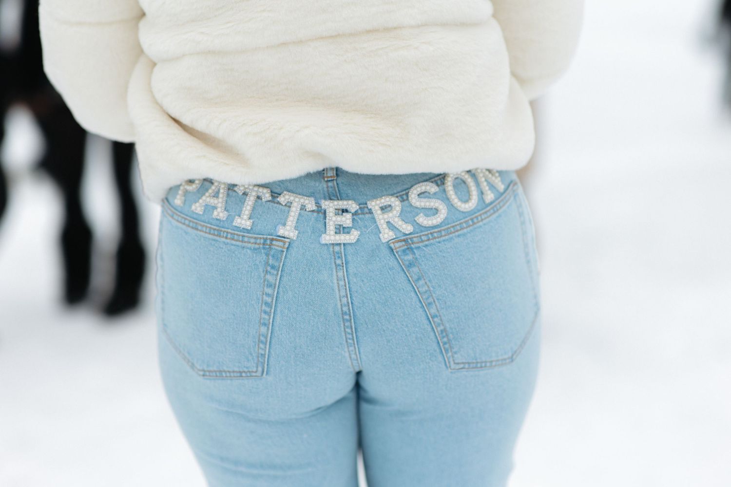 Close-up view of light blue denim jeans against a white background.