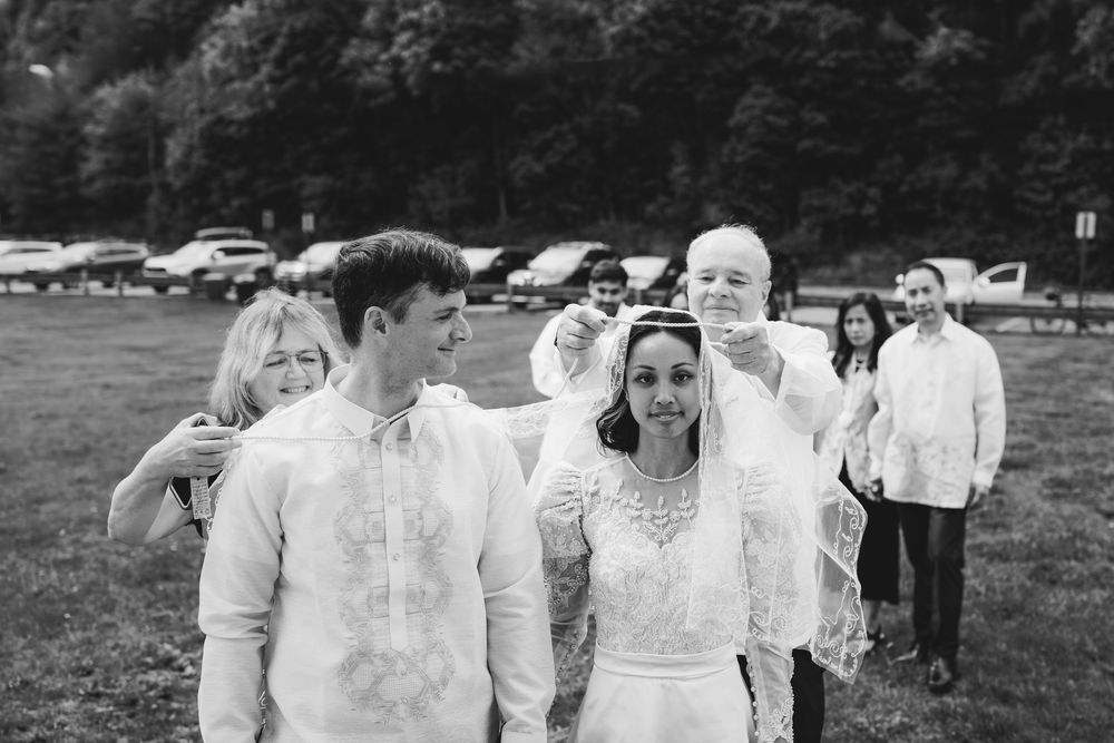 A black and white photo montage shows a group of people in white clothing walking together outdoors.