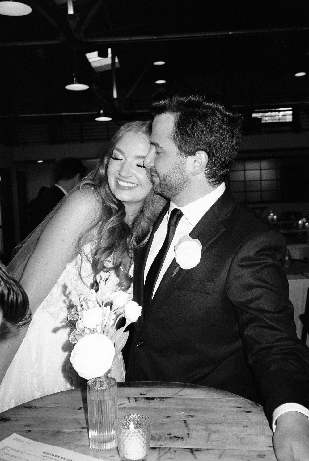 Black and white photo sequence showing tender moments between newlyweds at their wedding reception.
