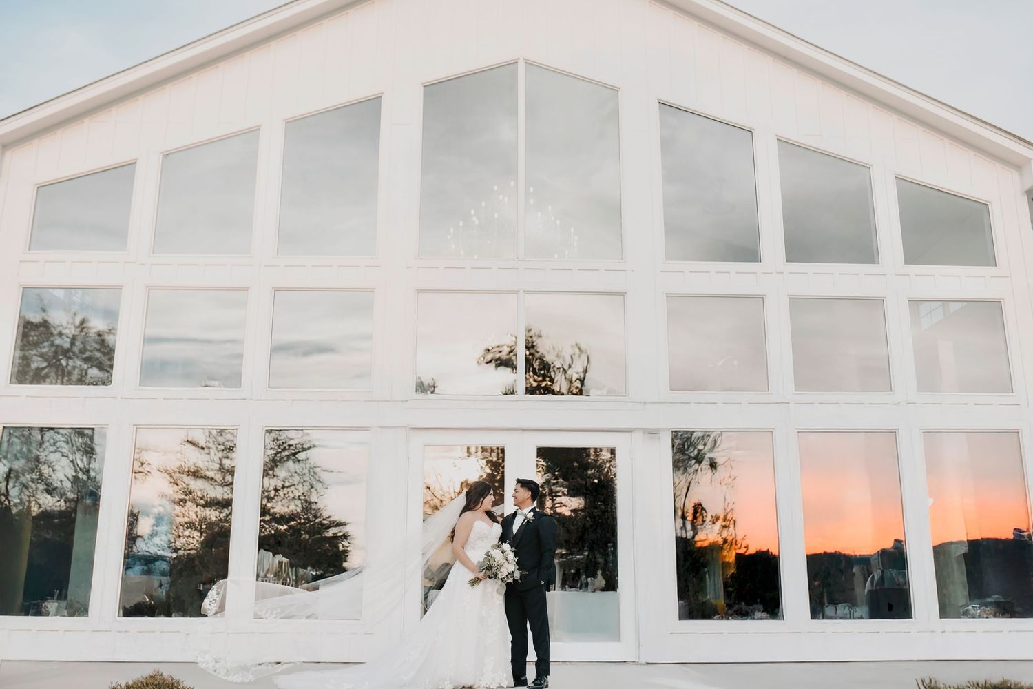 Veil flowing during romantic newlywed portrait