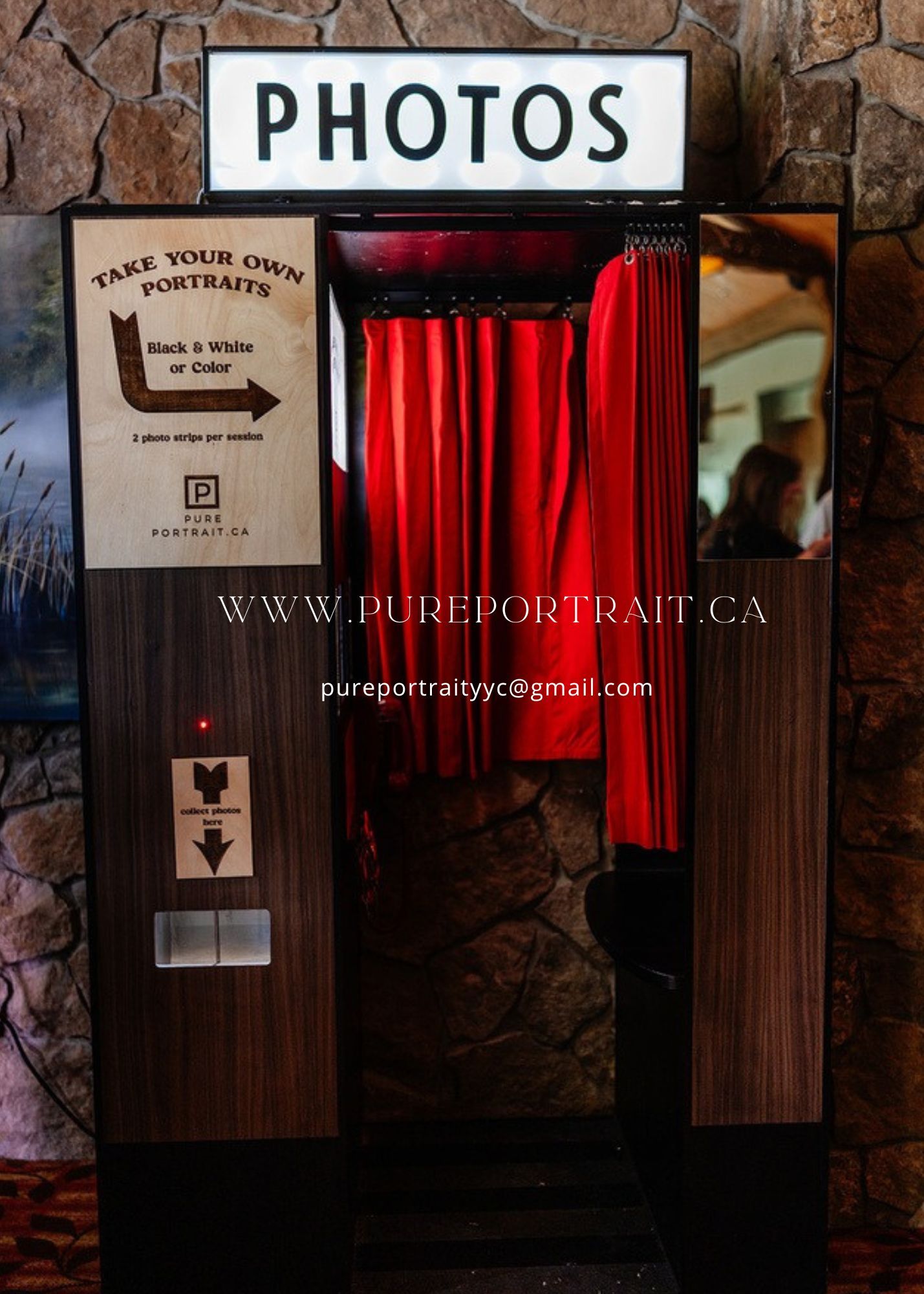 A dark wood-paneled wall with red curtains and signage displaying website and contact information for a portrait studio.