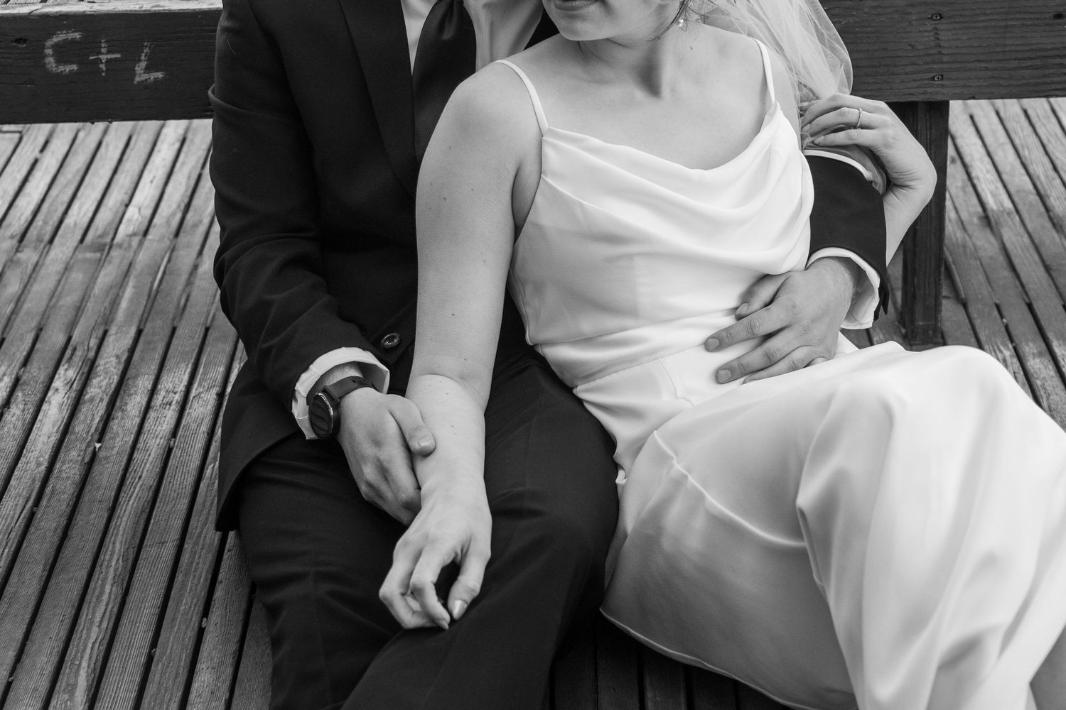 A black and white wedding photo collage showing intimate moments between a couple on a wooden deck.