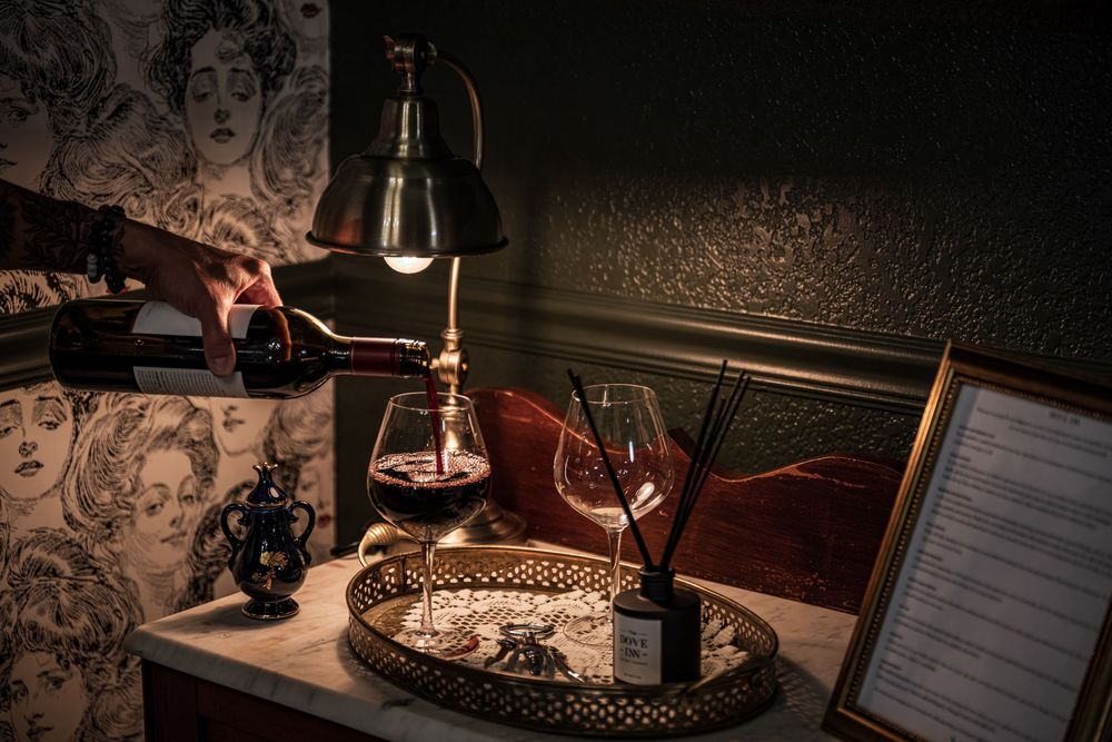 Detail shot of red wine being poured in the luxury boutique hotel The Dove Inn in Golden, CO.