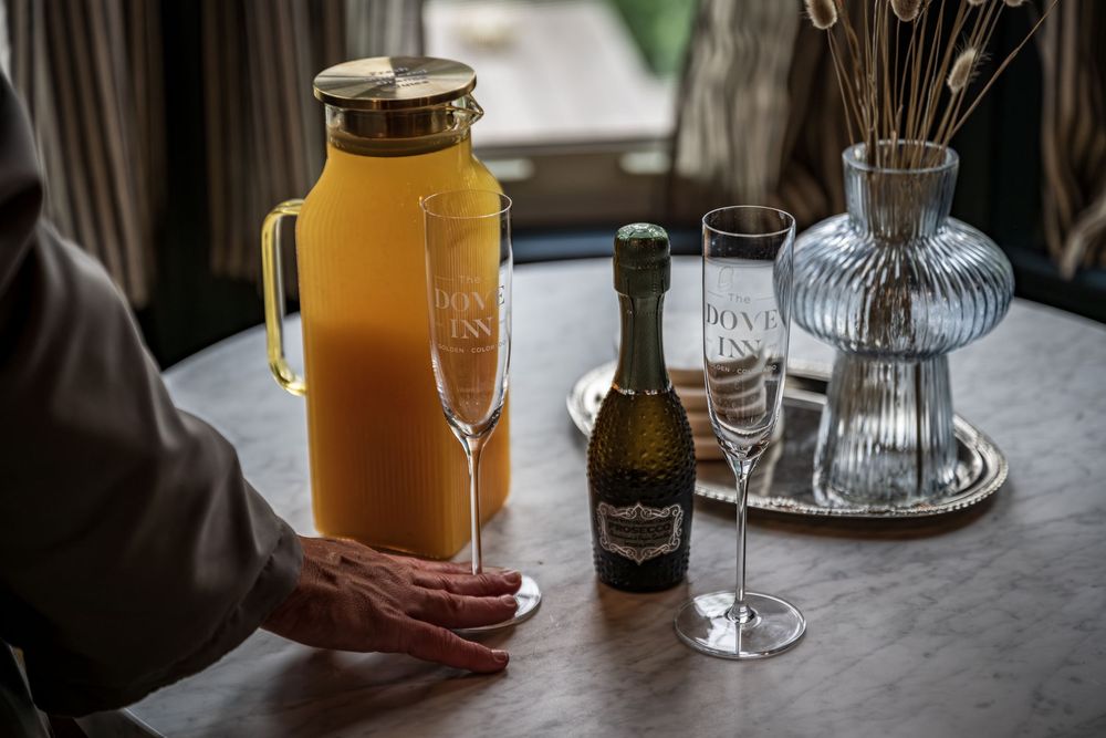 Orange juice and prosecco with champagne glasses in the luxury boutique hotel The Dove Inn in Golden, CO.