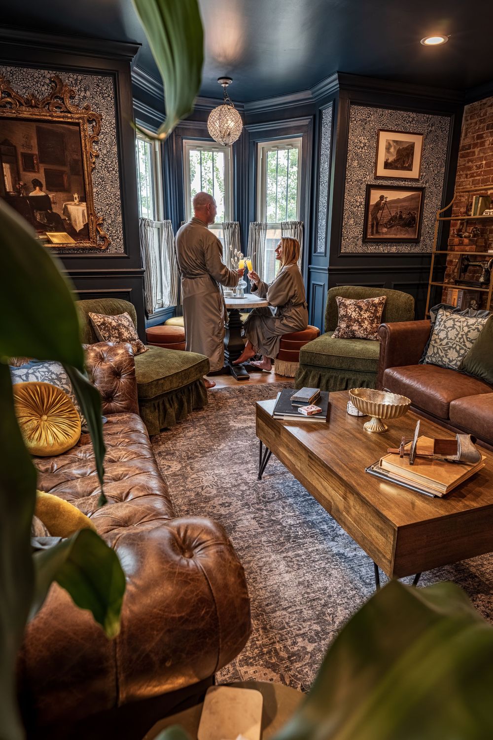 A couple drinking mimosas in robes in the luxury boutique hotel The Dove Inn in Golden, CO.