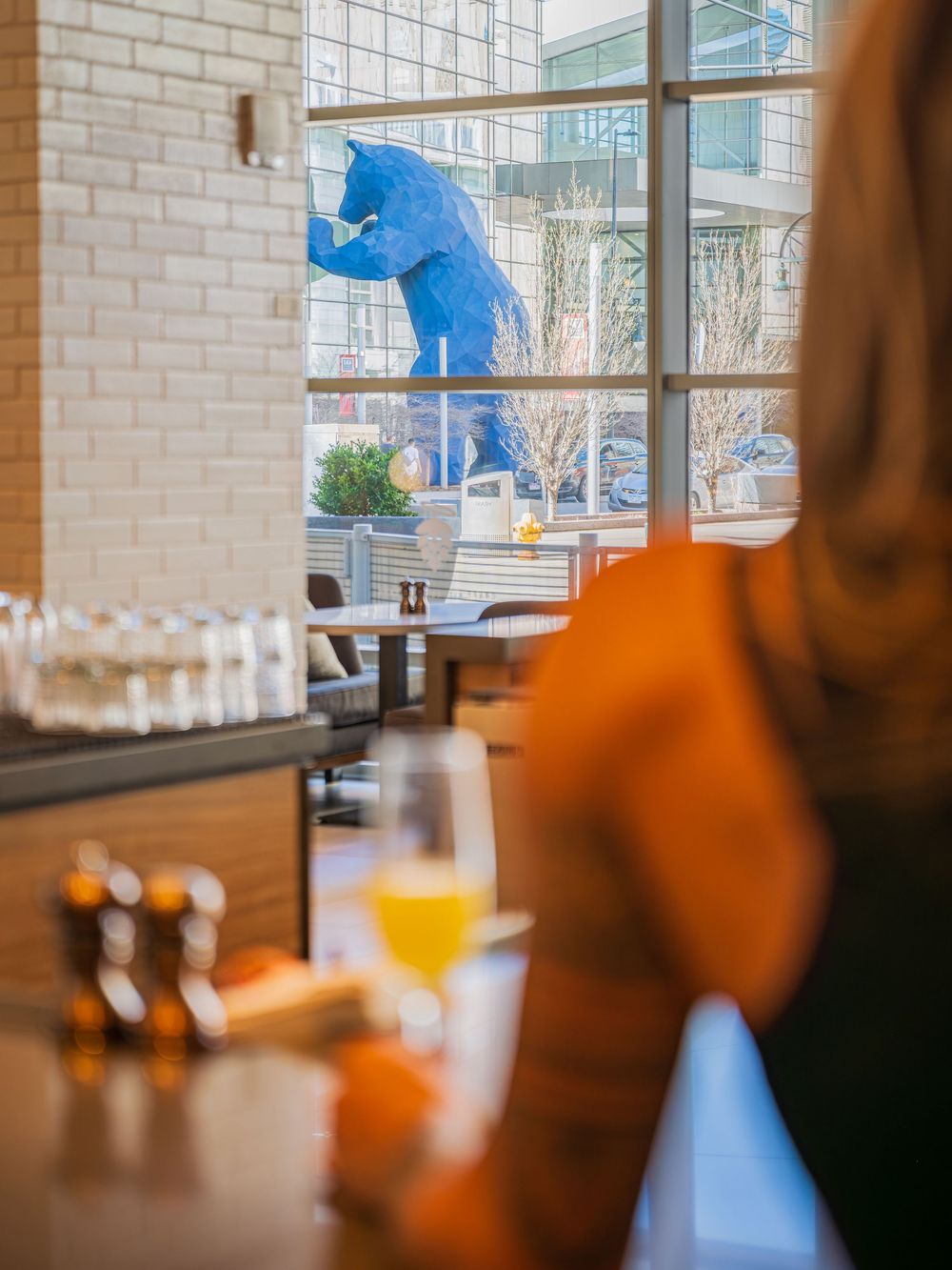 A woman at the bar in the Former Saint by Denver Hospitality, Travel & Tourism photographer Captain Colorado Photography.