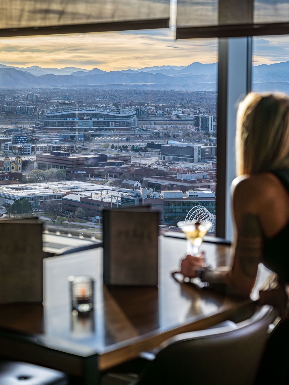 A woman taking in the views at the Peaks Lounge by Denver Hospitality, Travel & Tourism photographer Captain Colorado Photography.
