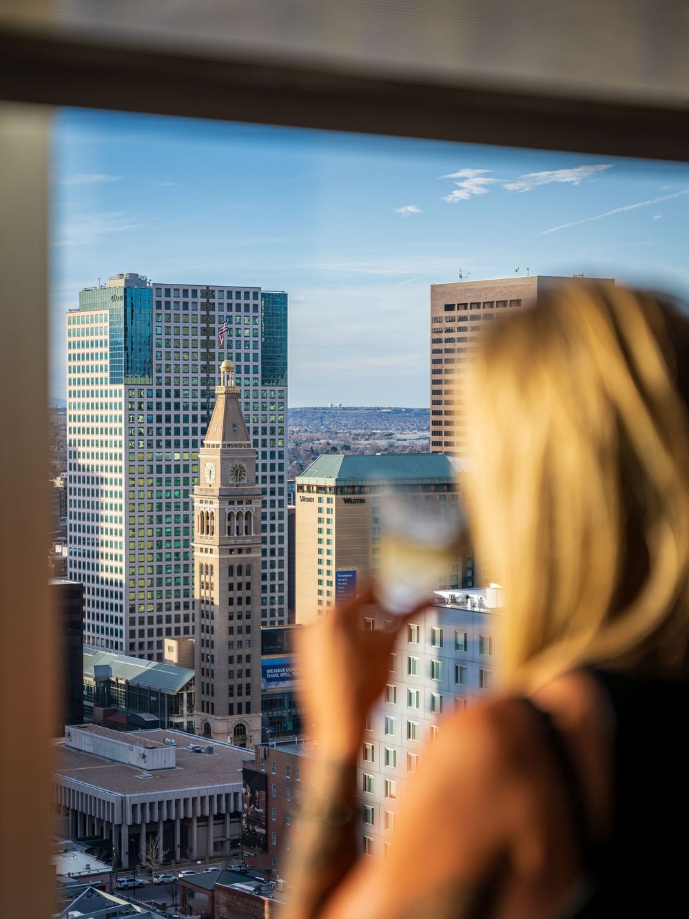 A woman sipping a cocktail at the Peaks Lounge by Denver Hospitality, Travel & Tourism photographer Captain Colorado Photography.