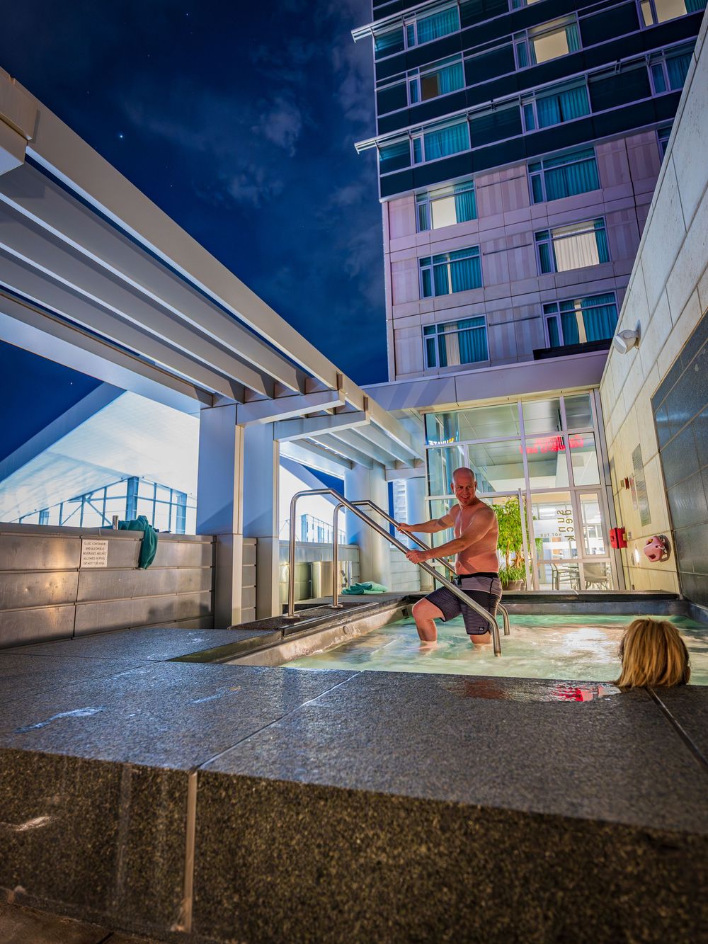 A couple enjoying the hot tub at the Hyatt Regency Denver by Denver Hospitality, Travel & Tourism photographer Captain Colorado Photography.