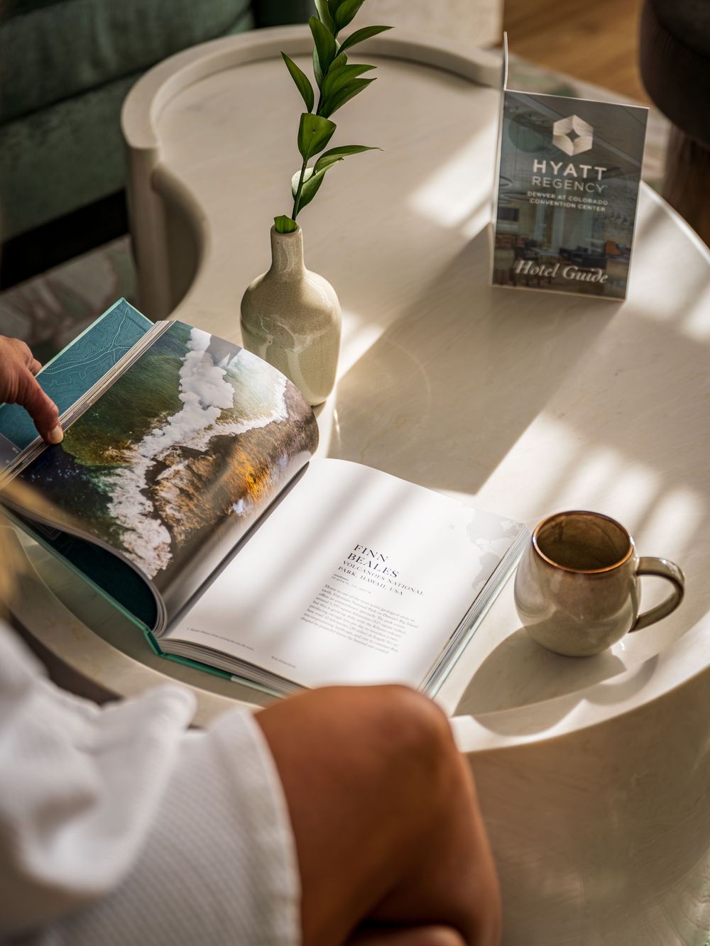 A woman reading in her robe at the Hyatt Regency Denver by Denver Hospitality, Travel & Tourism photographer Captain Colorado Photography.