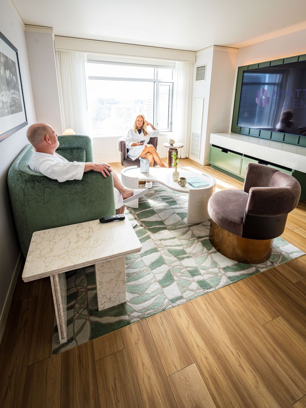 A couple relaxing in the room at the Hyatt Regency Denver by Denver Hospitality, Travel & Tourism photographer Captain Colorado Photography.