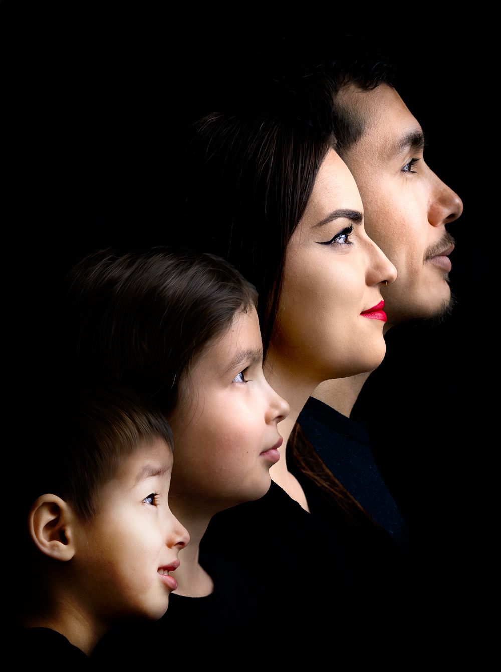Profile view of an Asian family with two children and parents against a black background.