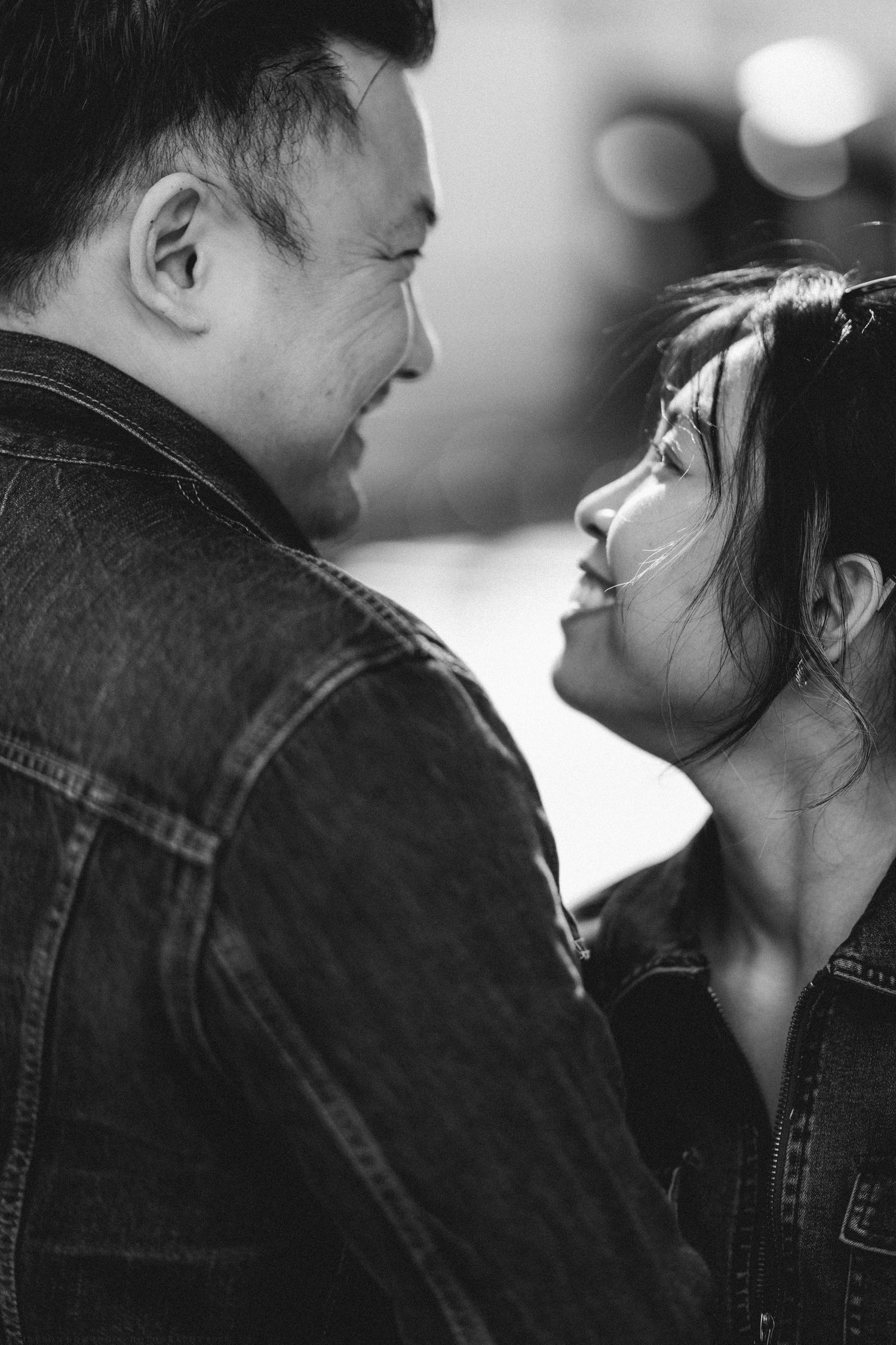 Intimate black and white portrait of a couple gazing at each other lovingly.