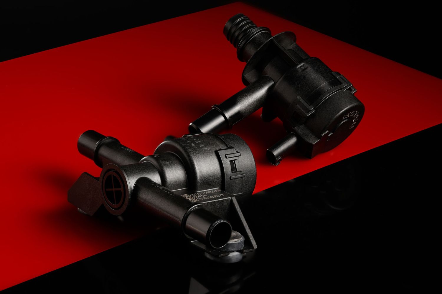 Studio product photography of automotive parts against a red and black background for Stant in Detroit Michigan.
