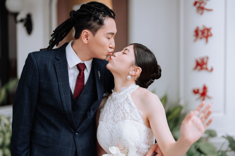 An intimate wedding portrait showing a tender moment between newlyweds.