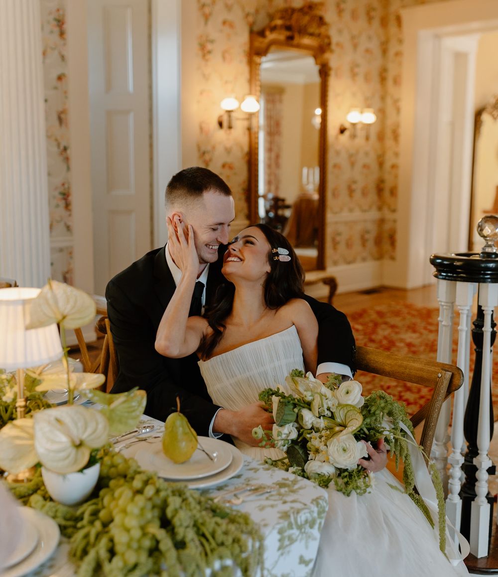Intimate moment at reception table decorated with white flowers and elegant table settings.