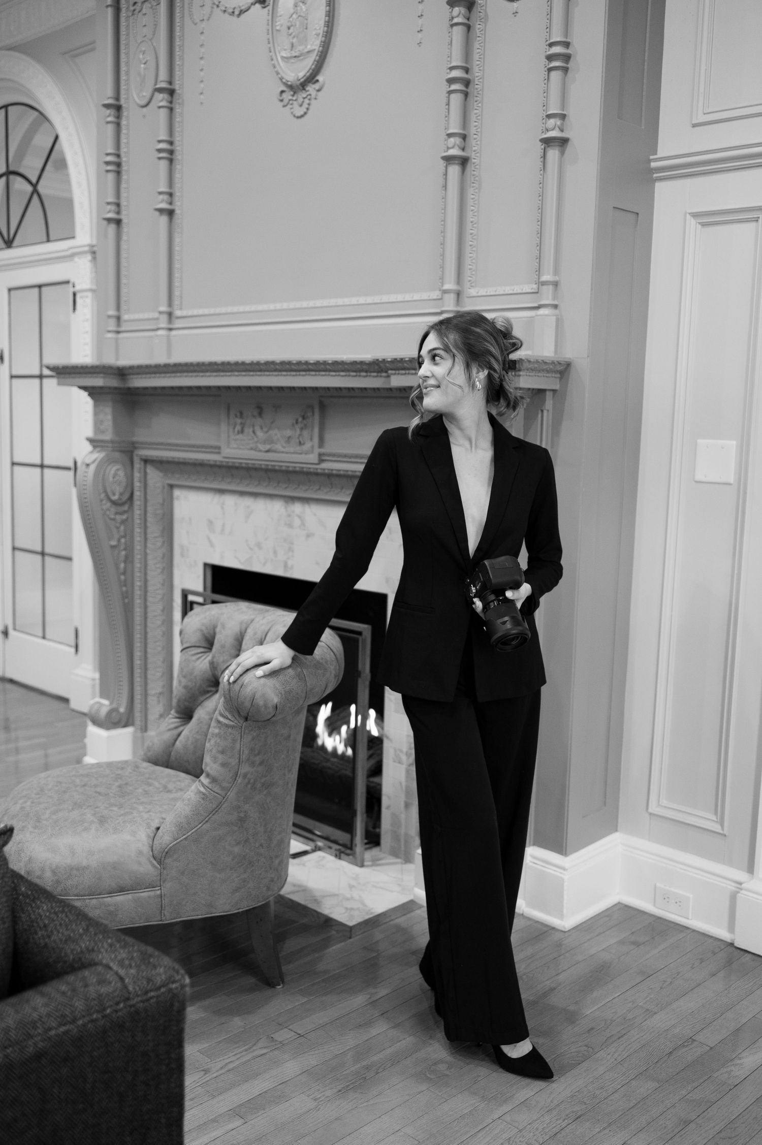 Black and white photo of an elegant room with vintage furniture and architectural details.