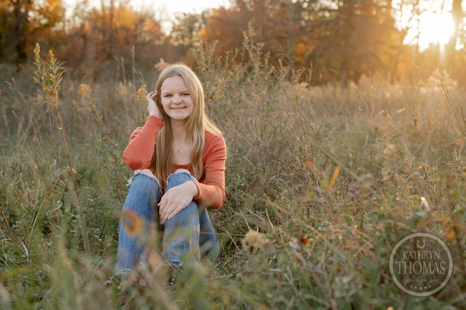 A casual outdoor portrait session in a wild autumn field during golden hour.