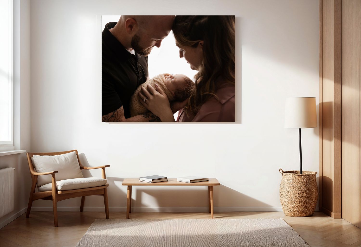 Neutral room with gorgeous canvas wall art of parents cuddling their newborn, taken by Somerset Portraits in Charlottesville.
