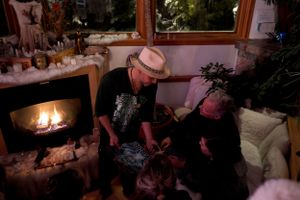 Cozy evening gathering by fireplace with warm ambient lighting.