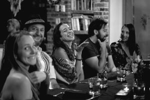 A lively group enjoying drinks and conversation at a bar counter.