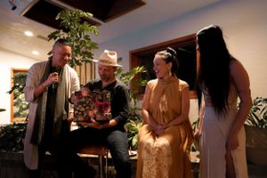 A group of people gathered for a casual indoor performance or presentation.