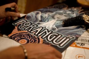 Close-up detail shot of a graphic t-shirt design with decorative text elements.
