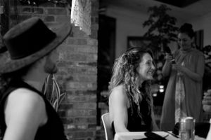 Two people engaged in conversation at what appears to be a social event or gathering.