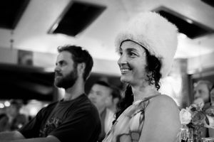 Black and white photo of people enjoying themselves at an indoor event.