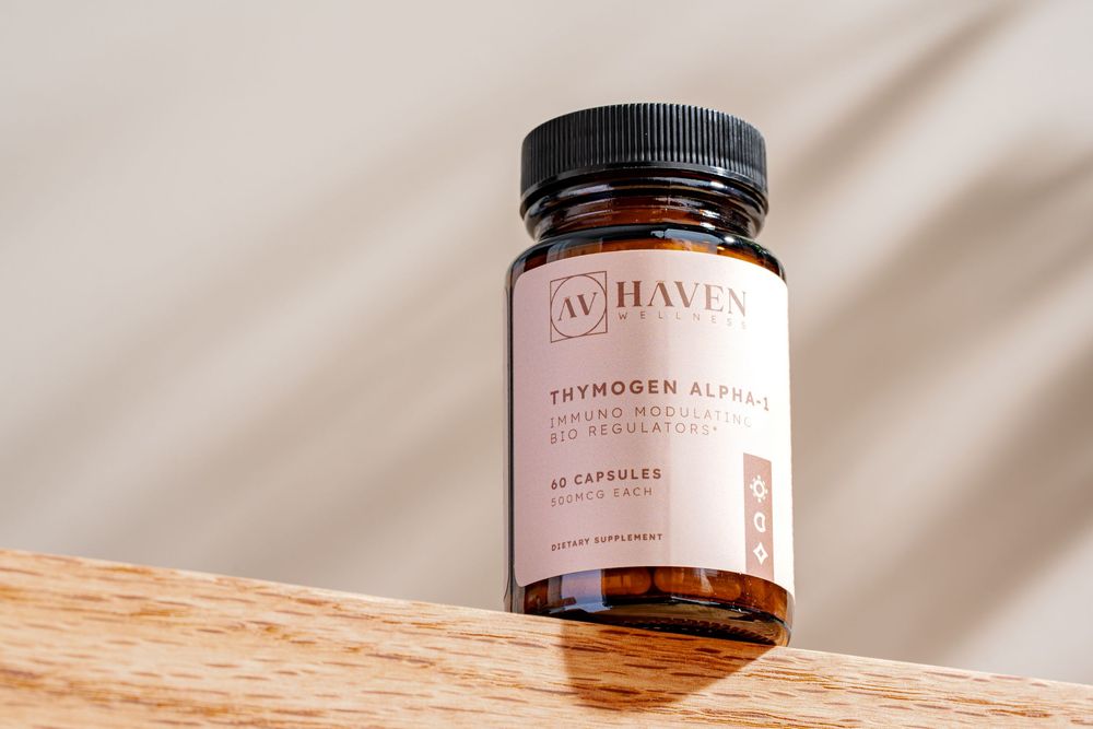 A dark glass supplement bottle with pink label sits on a wooden surface against a light beige background.
