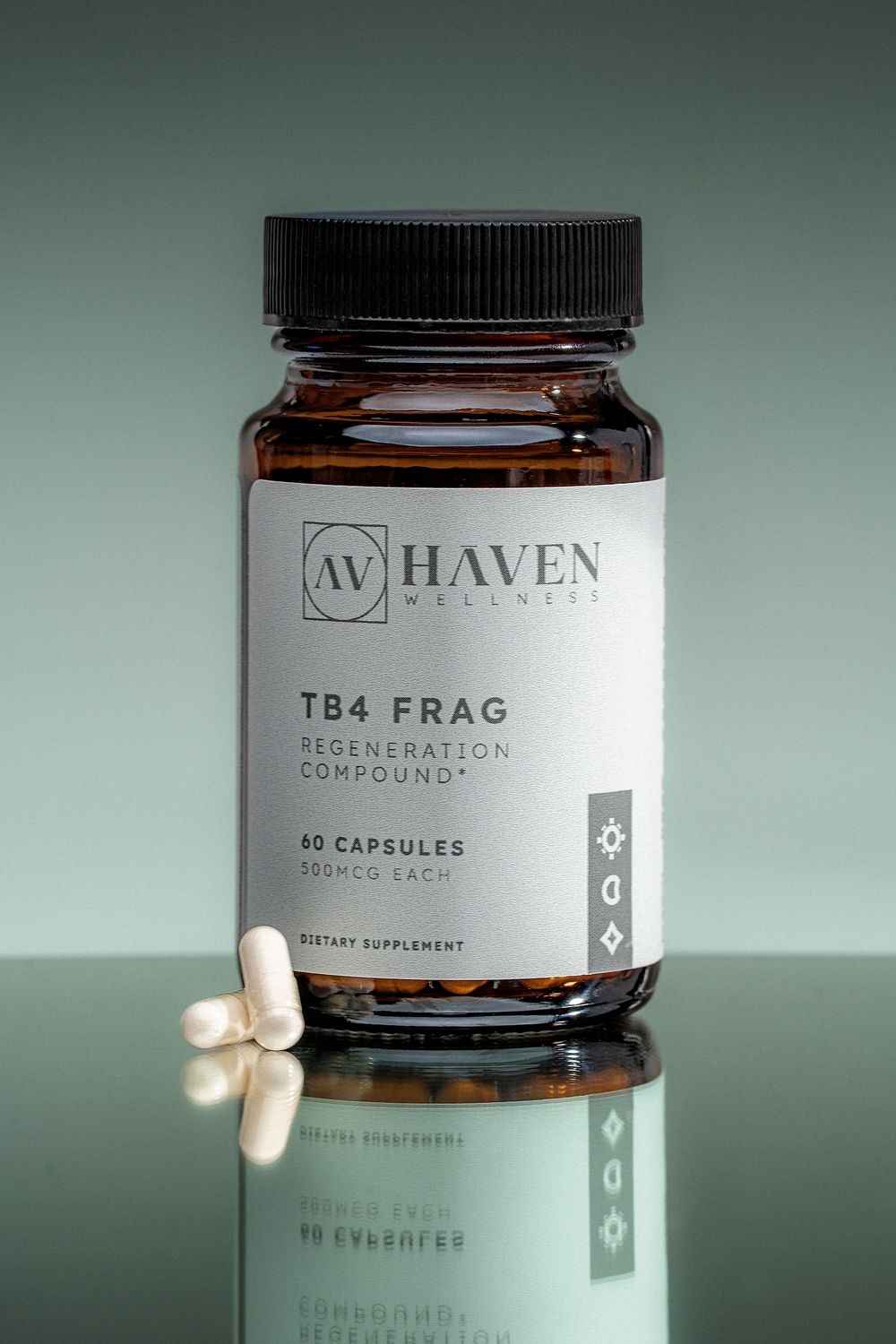 A bottle of Haven Wellness TB4 FRAG supplement capsules with white pills reflected on a glass surface.