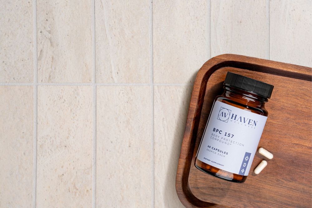 A brown glass jar with Du Hasly label sits on a wooden tray against a light-colored textured background.