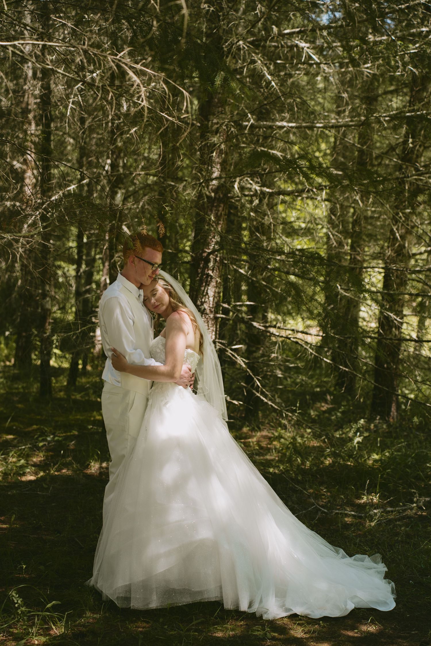 A romantic wedding photo shoot in a lush forest setting.