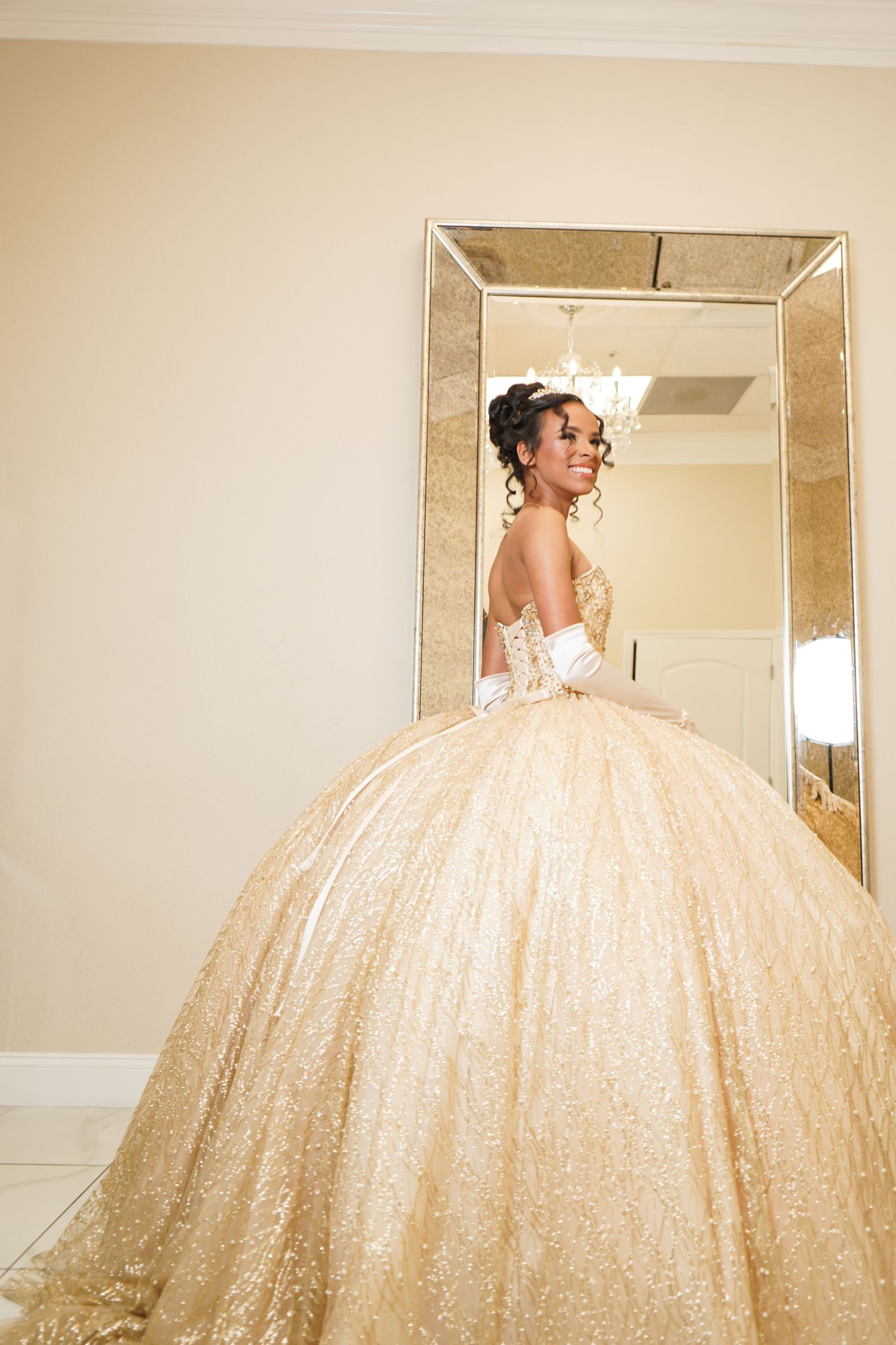 Reflections of sparkly champagne-colored ballgown in ornate gold mirror sequence.
