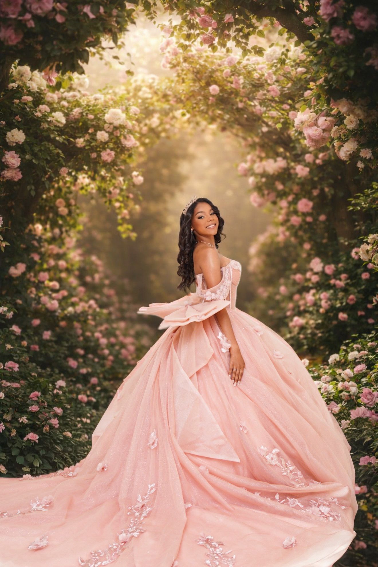 A pink ballgown with floral details is showcased in a dreamy garden setting with blooming roses and golden sunlight.