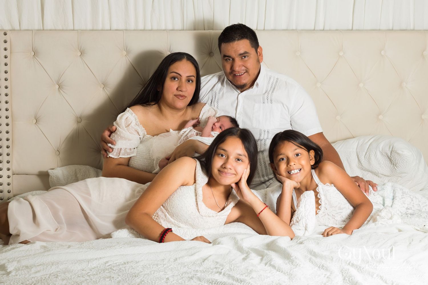A sequence of affectionate couple portraits in white bedding shows intimate moments together.