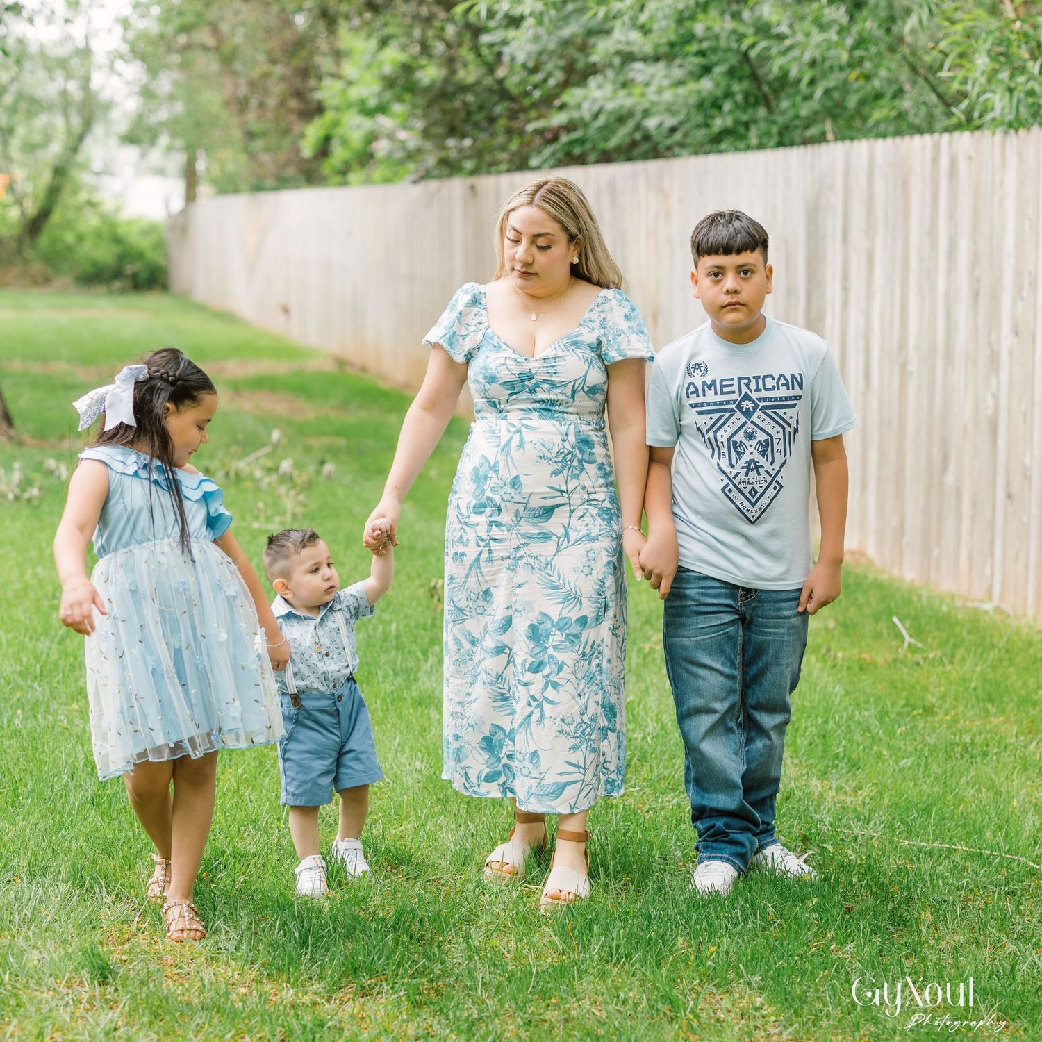 Family photo session shows multiple candid moments with children walking and playing in a grassy outdoor setting.