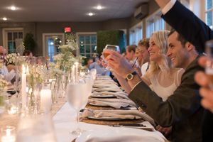 Elegant dinner table setting with crystal chandeliers and formal place settings.