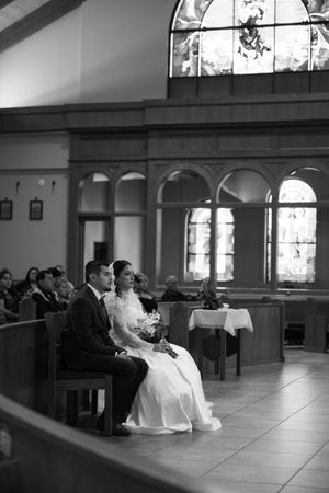 Black and white panoramic sequence showing a wedding ceremony in a church with stained glass windows and pews.