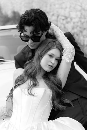 A black and white series of artistic bridal portraits featuring a white dress, lace sleeves, and dramatic poses.