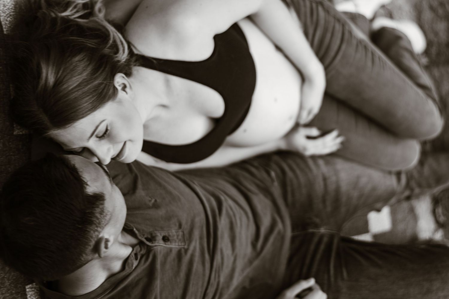 Intimate black and white portrait of couple sharing gentle embrace.