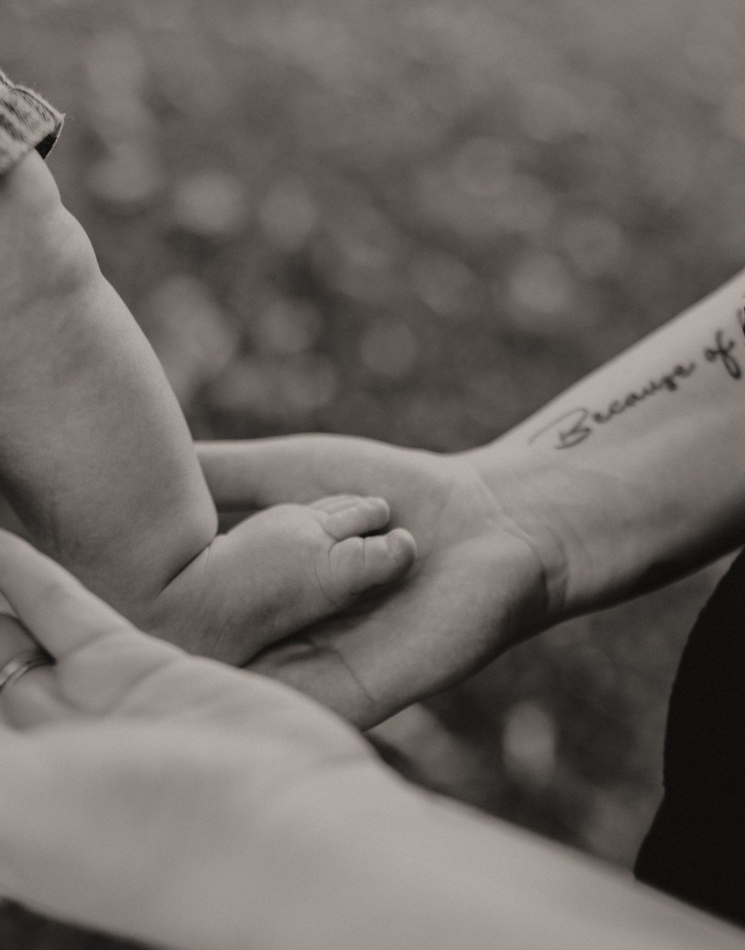Close-up black and white image of hands touching and connecting.