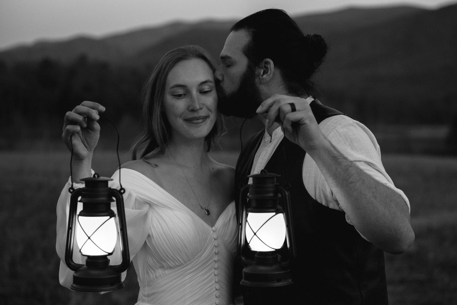 bride and groom stand with their foreheads together during a sunset