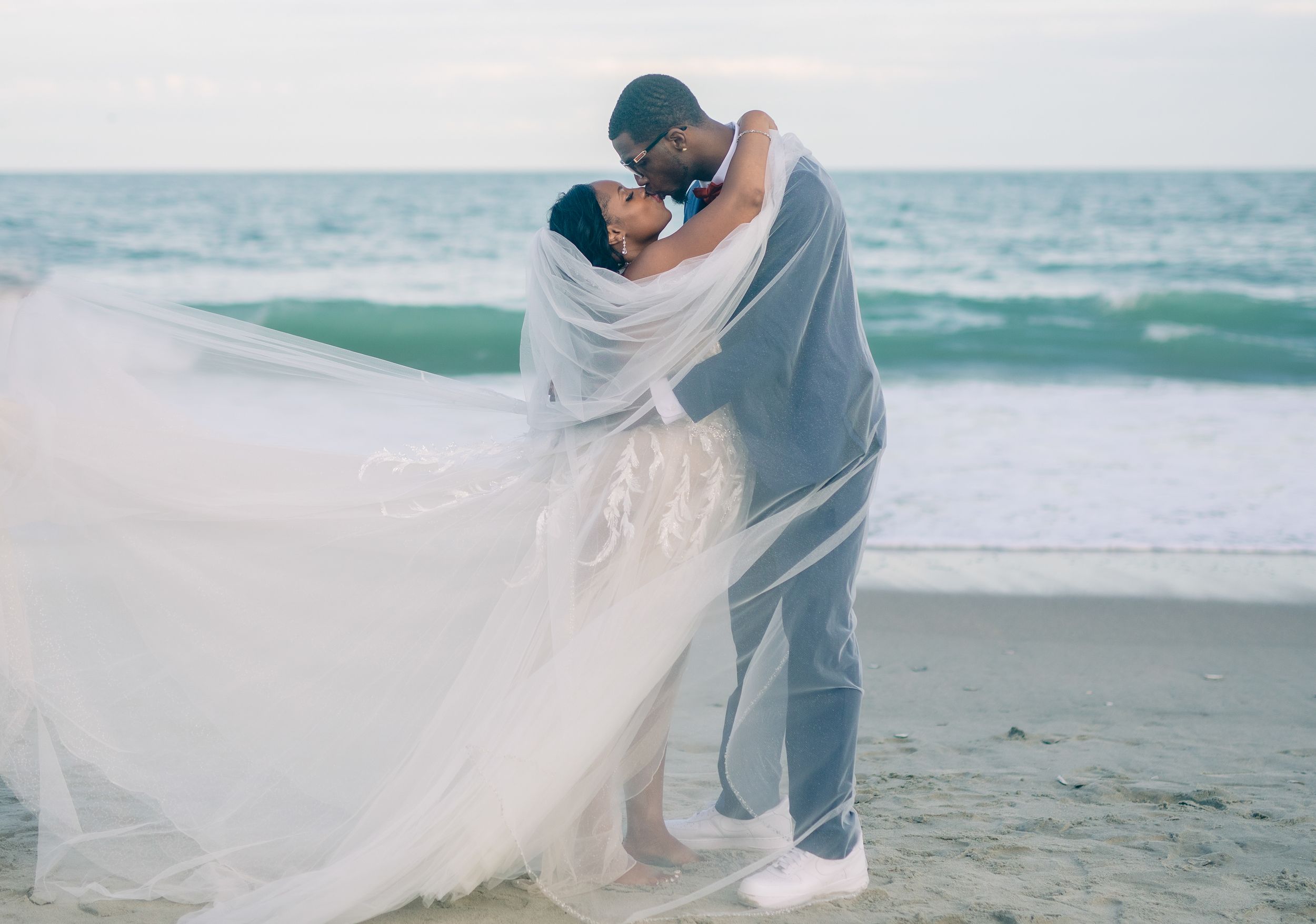 Emotional kiss at outdoor beach wedding, captured by local photographer Tasha Cannaday in Essex County.