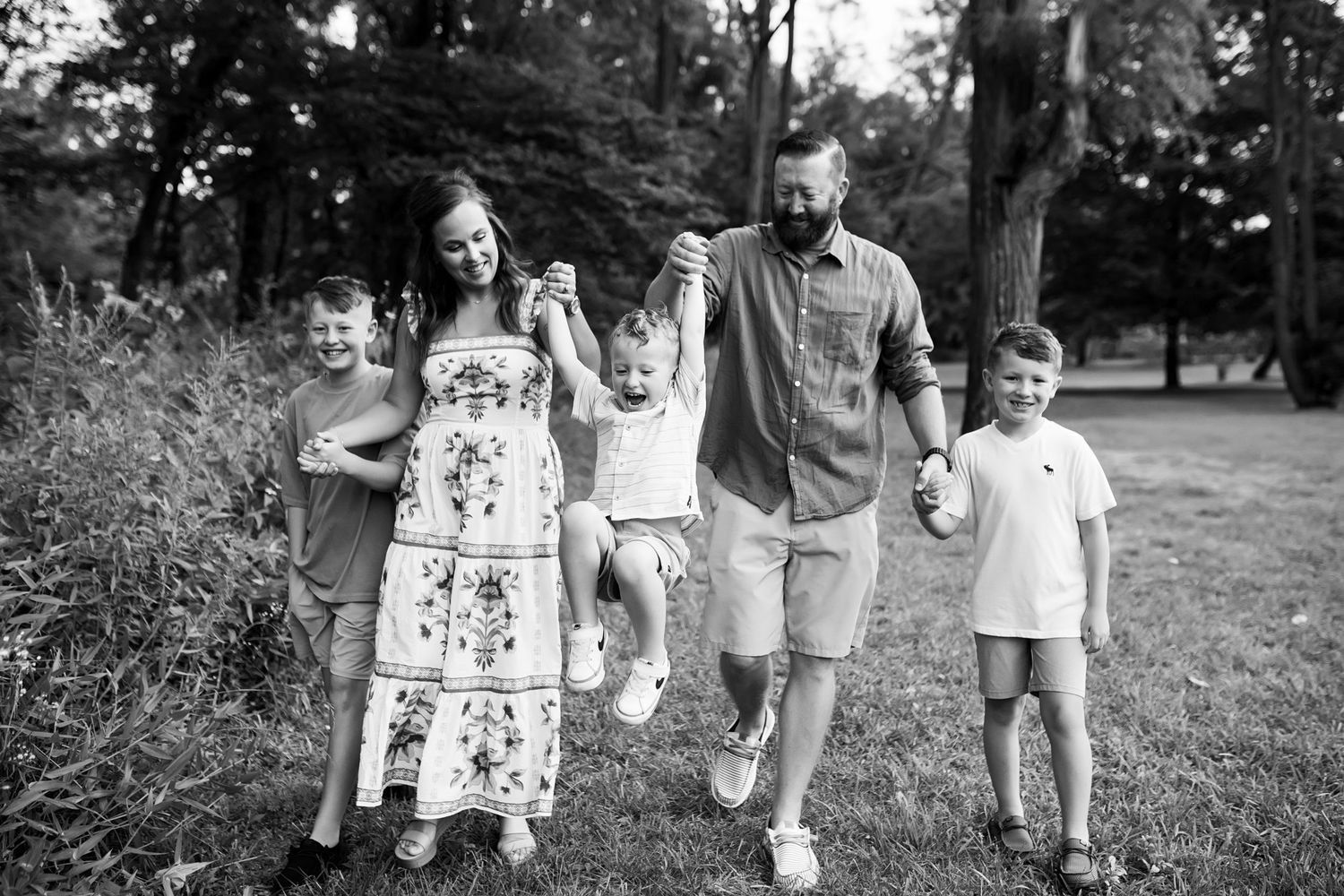 A black and white photo sequence shows a family walking together in casual attire along an outdoor path.